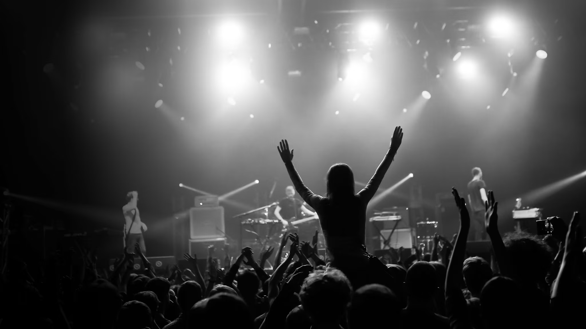 An audience celebrating beneath live stage lights and confetti